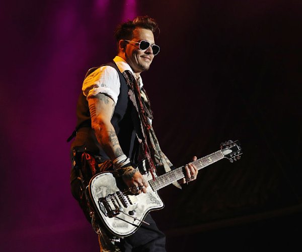 johnny depp performs at a concert