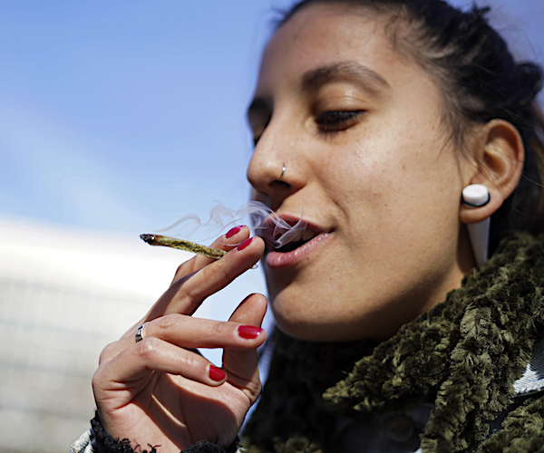 a woman smokes a marijuana joint