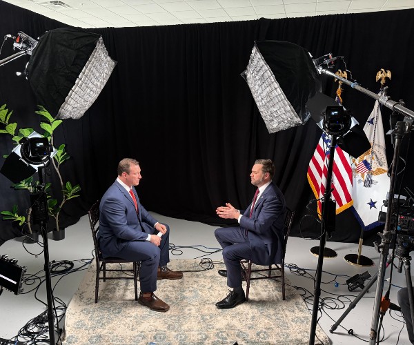 carl higbie and jd vance sit across from each other