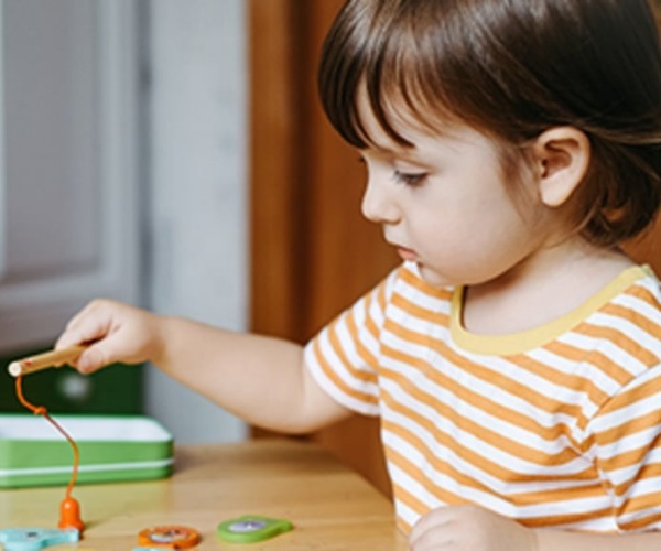 young child playing with a toy