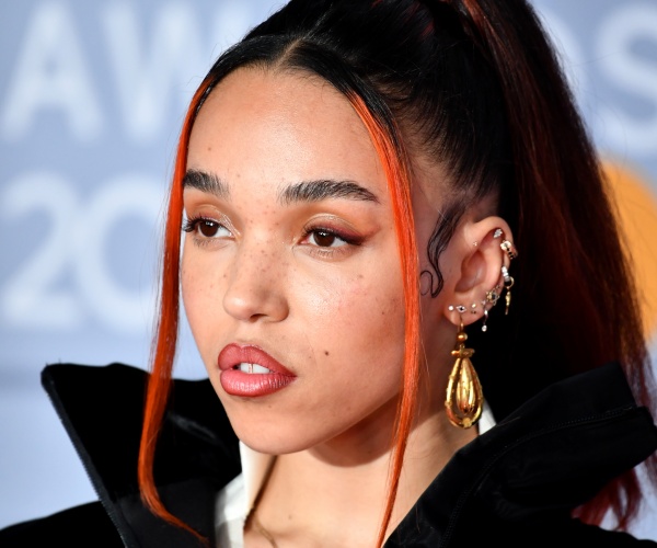 fka twigs in a black dress with front pieces of her hair dyed orange