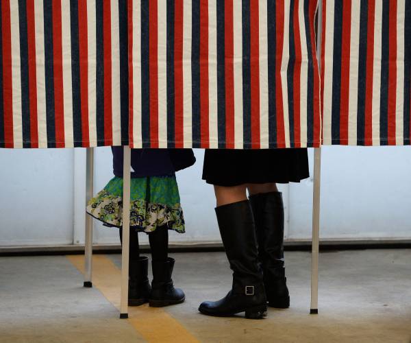 a woman and child in a voting booth