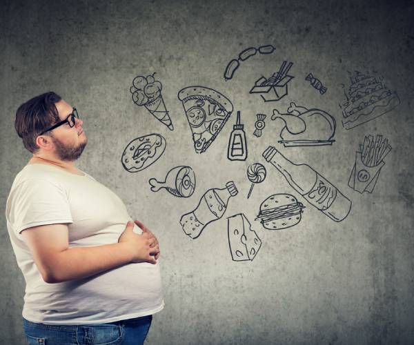 an obese man looking at drawings of different types of food