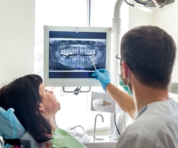 dentist showing a patient their dental x-rays