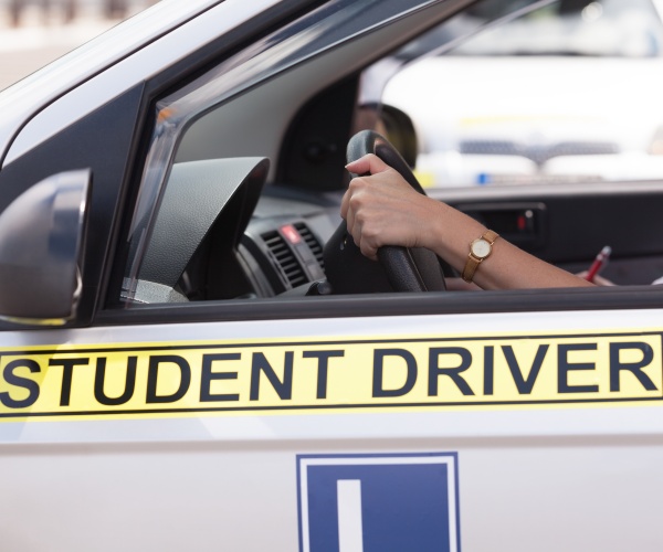 side of car with sign that says "Student Driver"