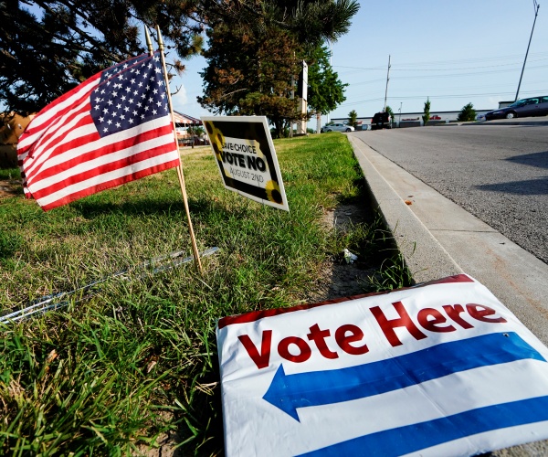 a vote here signs lays on the ground