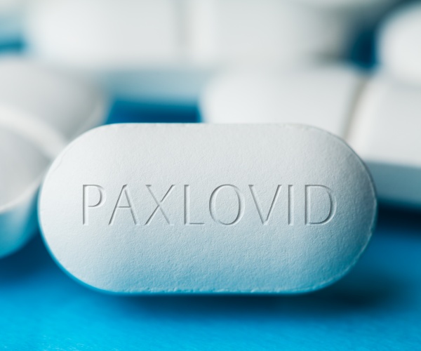 large white pill with "Paxlovid" on it