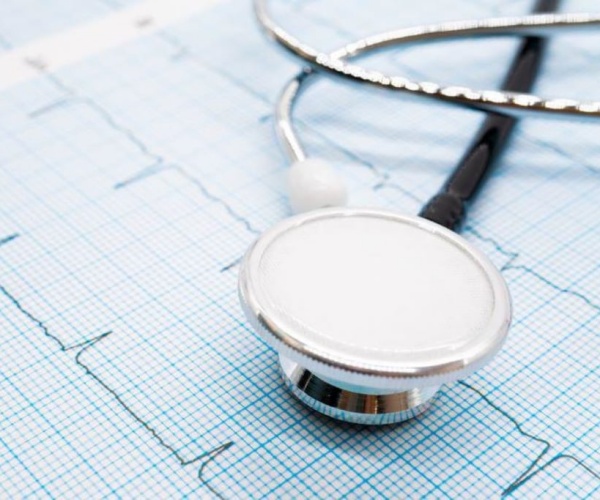 stethoscope on printout of a patient's heart rhythm