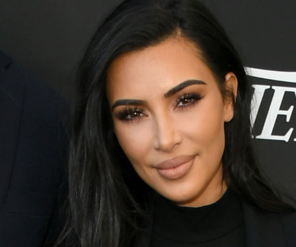 kim kardashian west smiling during a red carpet event