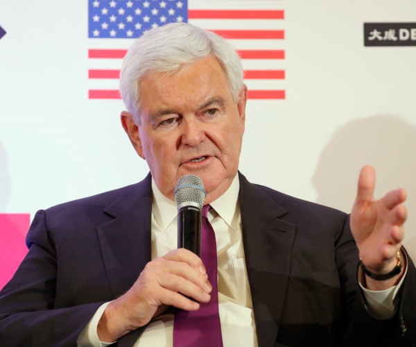 gingrich in a black suit and purple tie