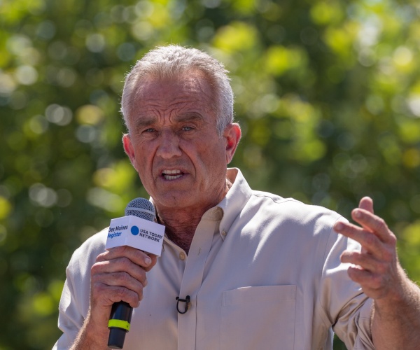 Robert F. Kennedy, Jr speaking outside with a microphone at a function