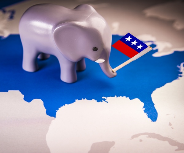 toy elephant holding a republican party flag over a united states map