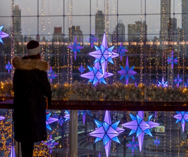 woman looking out at holiday lights