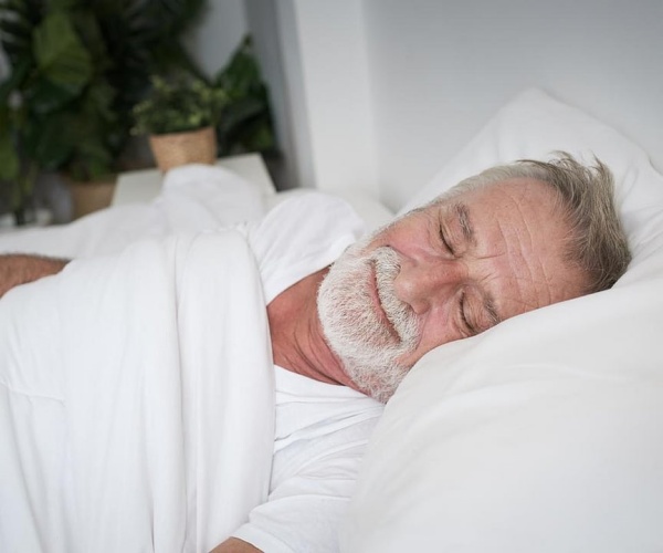 man sleeping in bed