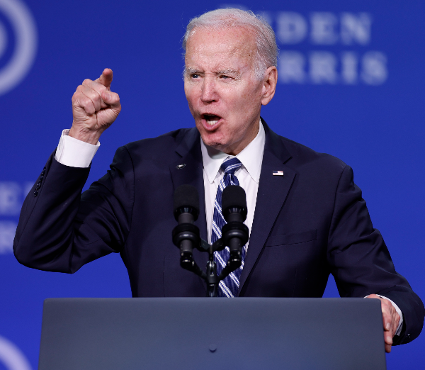 joe biden gestures while speaking at a podium