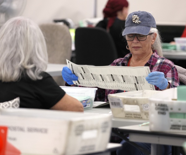 election workers open mail-in ballots