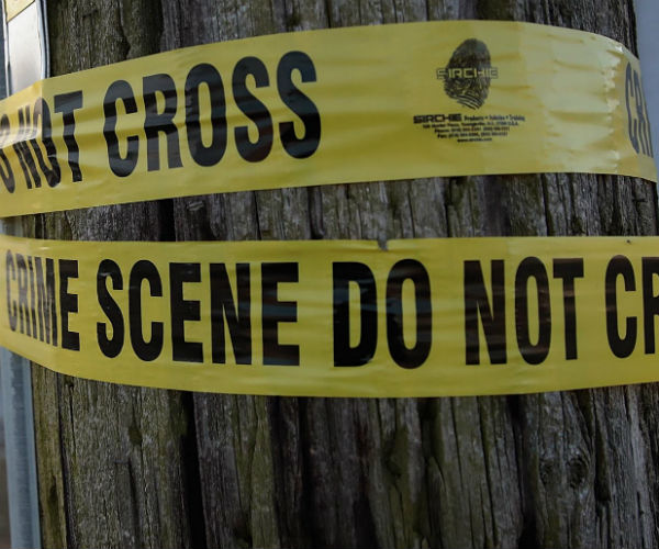 crime scene tape on a telephone pole