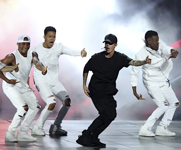 justin bieber dances on stage during a performance with his dance team