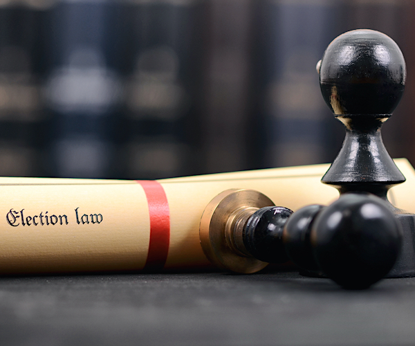 election law scroll and black pawns