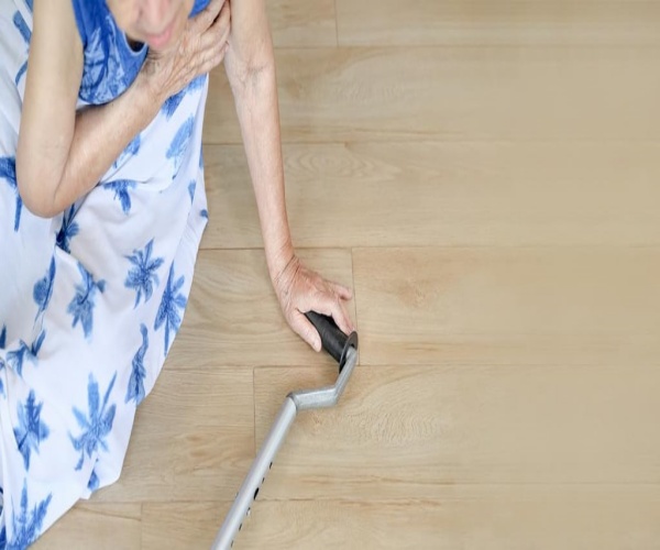 woman with cane on ground after a fall