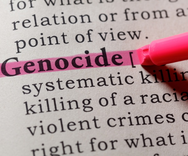 dictionary definition of the word genocide with pink highlighter