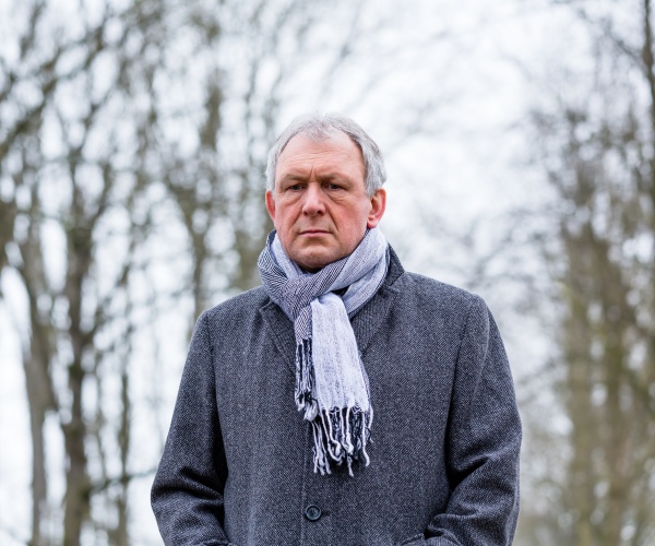 man outside on cold winter day looking sad