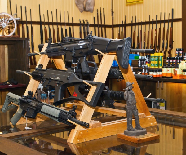 interior of a gun shop with display of military looking semi-automatic assault rifles