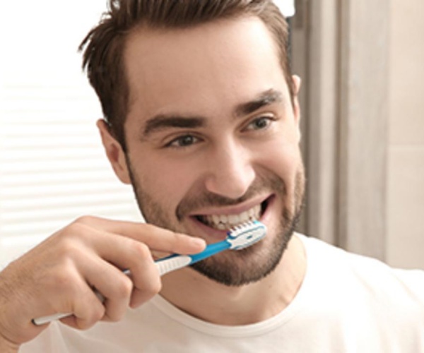 man brushing teeth