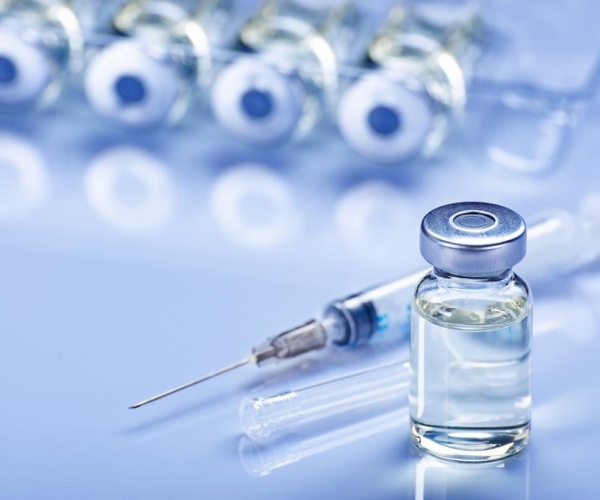 vials of vaccine, syringe