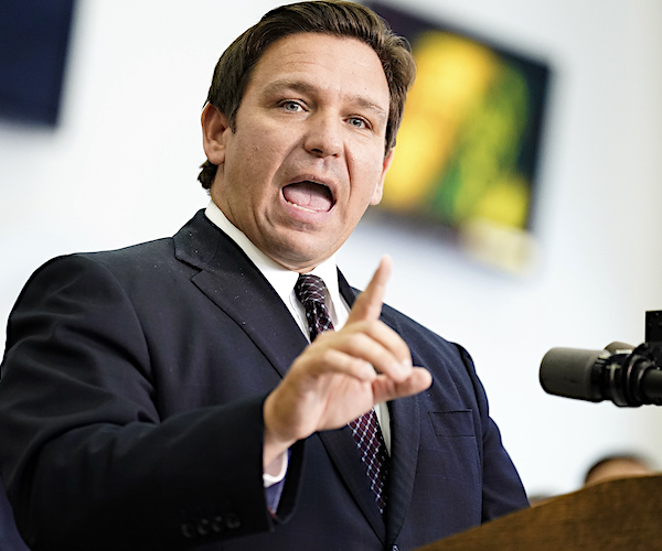 ron desantis points and speaks during a florida news conference