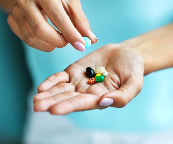 woman's hands holding supplements