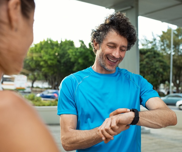man looking at smartwatch after exercising