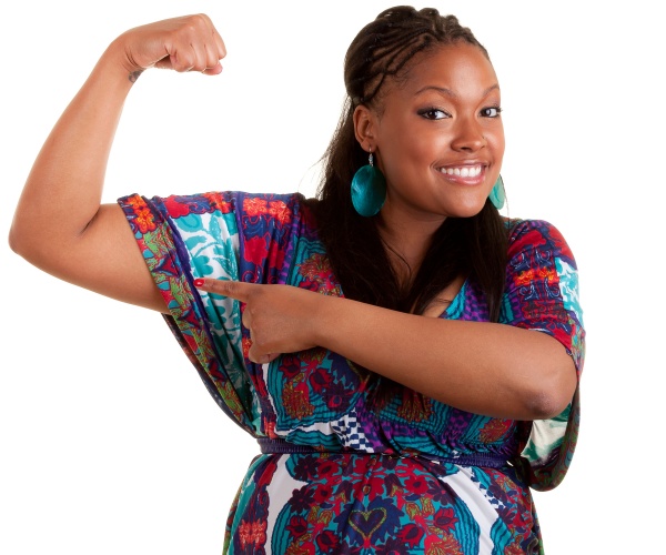 woman holding up arm showing muscle