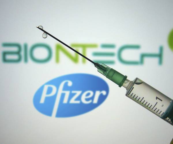 pfizer logo with vaccine in foreground