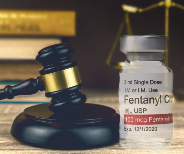 a fentanyl bottle next to a judges gavel