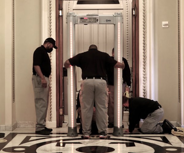 workers installing a metal detector