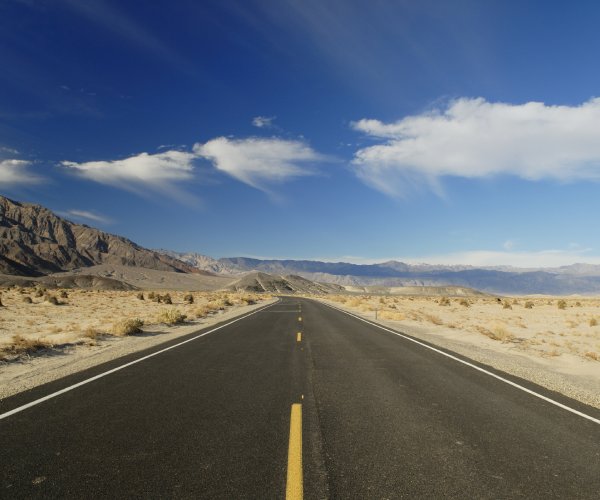 a road runs through caliornia's mojave desert