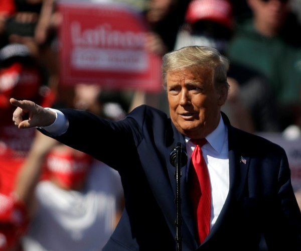 donald trump points at crowd while standing onstage