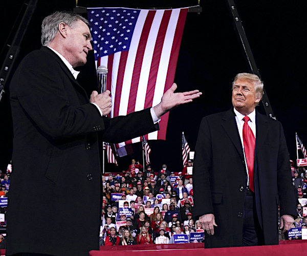 david perdue points to and thanks president donald trump at a valdosta georgia rally