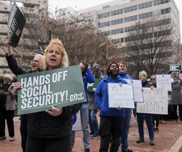 protesters hold signs