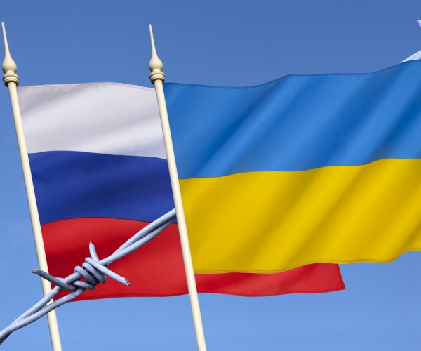 flags of russia and ukraine with barbed wire