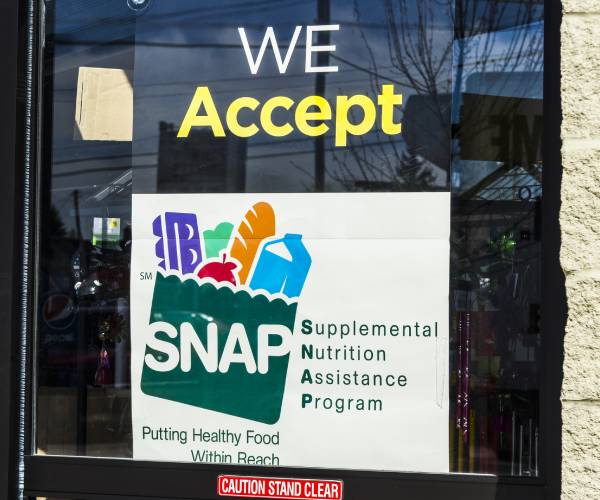 a sign in a store window reading we accept snap