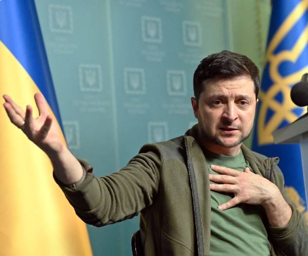 zelensky gestures as he speaks to reporters