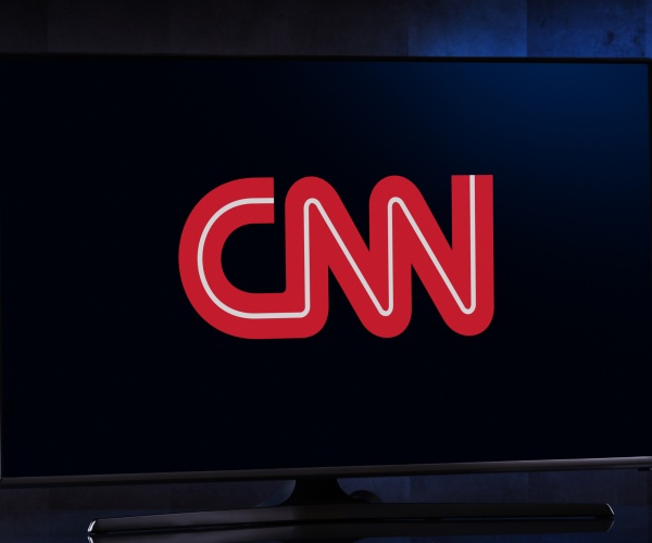 flat screen tv set displaying logo of cnn cable news network