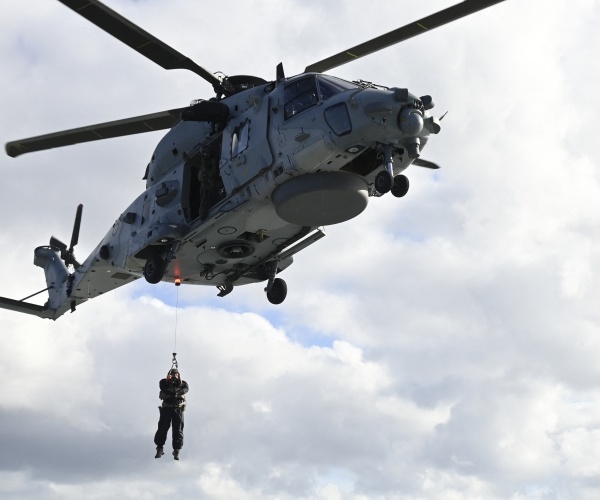 man drops from helicopter