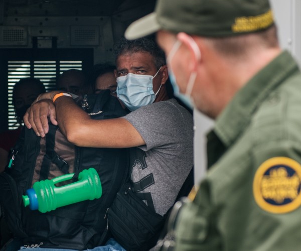 immigrants preparing to be taken to border patrol processing 