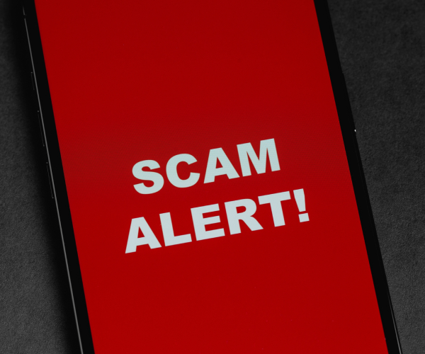 a smartphone with scam alert written on the screen in large letters