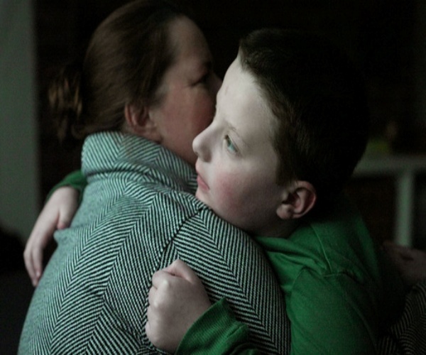 one of the Murphy boys with profound autism hugging his mother