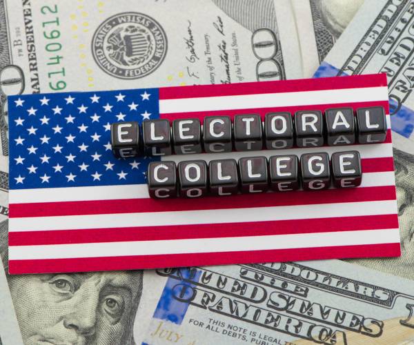 the words electoral college on an american flag and a spread of hundred dollar bills