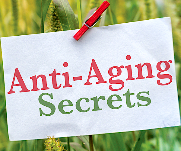 a placard in a tall grass field reads anti-aging secrets